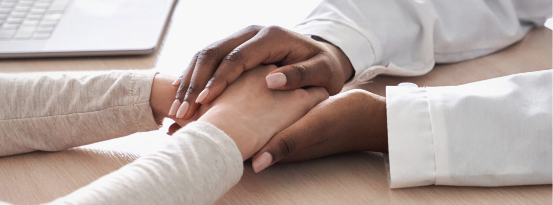 What is Diabulimia? A doctor holds hands with patient.