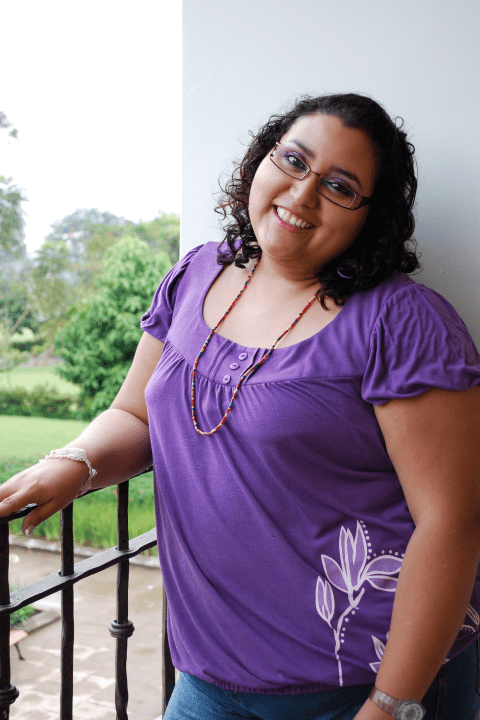 Woman in purple smiling | Eating Disorder Treatment Community