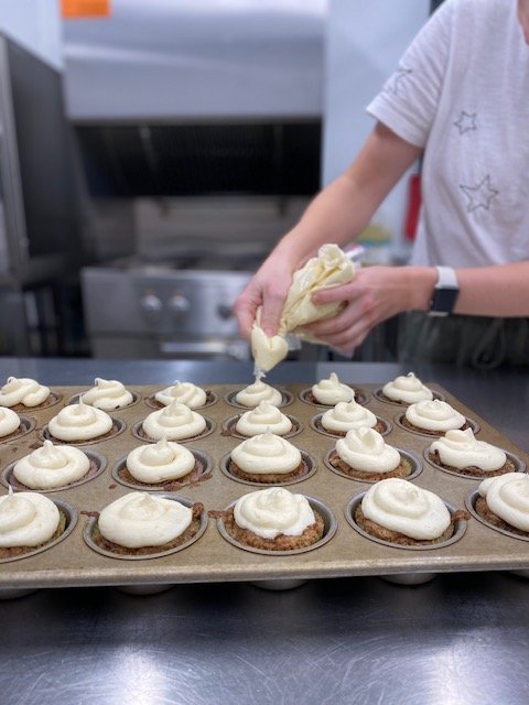 “Baking and interacting with food has been a great exposure therapy in helping me conquer my fear foods” (Client). | Each week, a client is selected by their team to choose a group snack. On this week, carrot cake cupcakes with cream cheese frosting were both chosen and prepared by a client, who used to eat carrot cake cupcakes for her birthday each year.