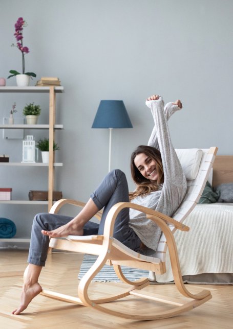 Woman sitting in a chair with her arms stretched out
