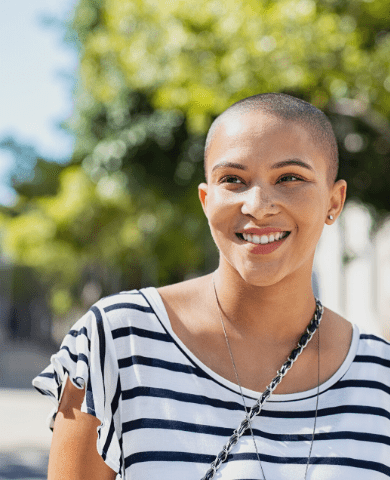 young woman wearing a striped shirt, smiling | Eating Disorder Treatment Community