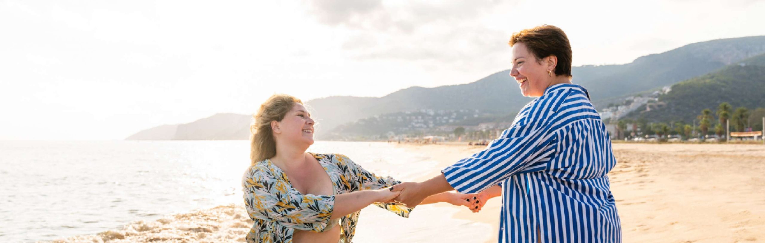 two people dancing on the beach