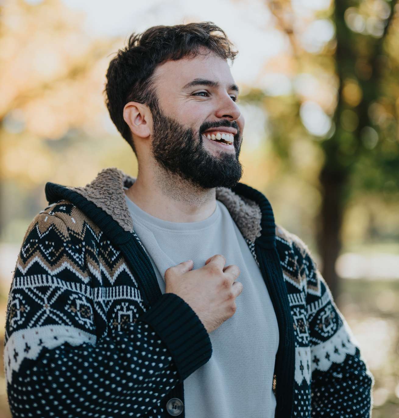 man in a sweater laughing