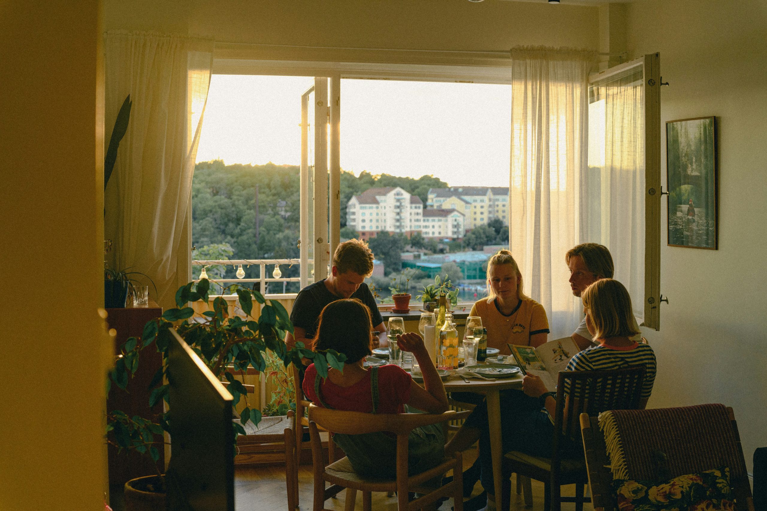 family sitting around the dinner table | alsana.com